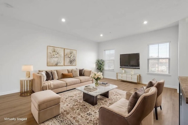 living room with plenty of natural light and light hardwood / wood-style floors