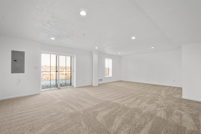 empty room with light carpet and electric panel