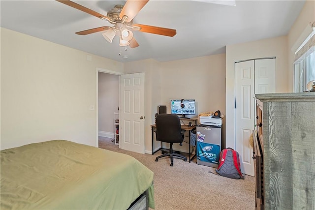 bedroom with ceiling fan, a closet, and light carpet