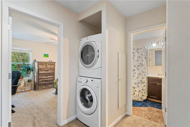 laundry room with light carpet, sink, and stacked washer / dryer