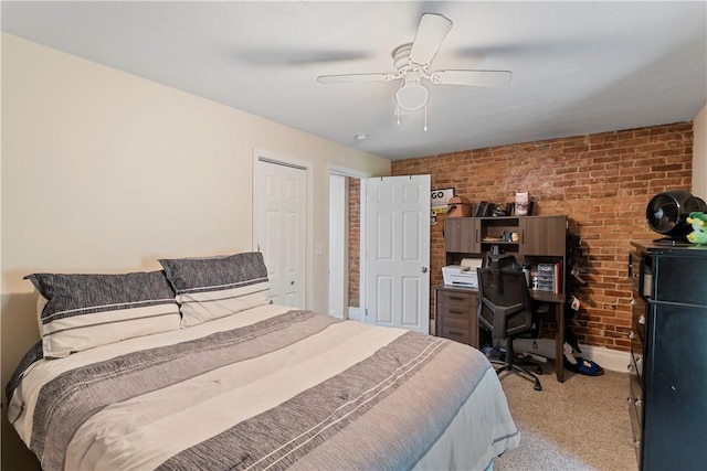 carpeted bedroom with ceiling fan and brick wall