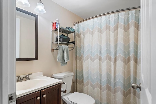 bathroom featuring vanity, toilet, and a shower with shower curtain