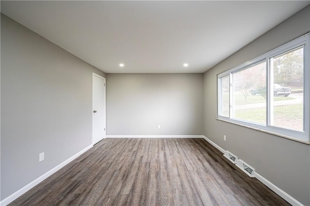 spare room featuring dark wood-type flooring