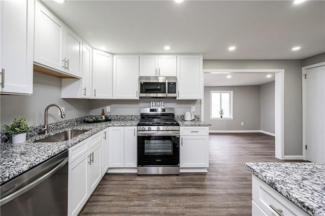 kitchen featuring sink, white cabinets, stainless steel appliances, and dark hardwood / wood-style floors