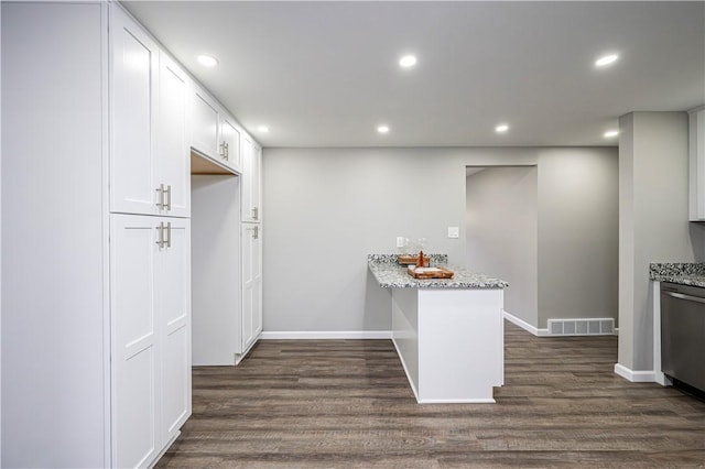 kitchen with kitchen peninsula, light stone countertops, dishwasher, and white cabinets