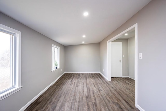 empty room with dark hardwood / wood-style flooring