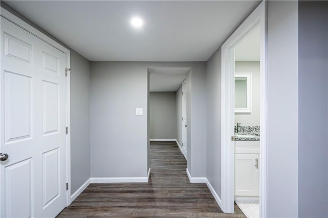 hallway with sink and dark hardwood / wood-style floors