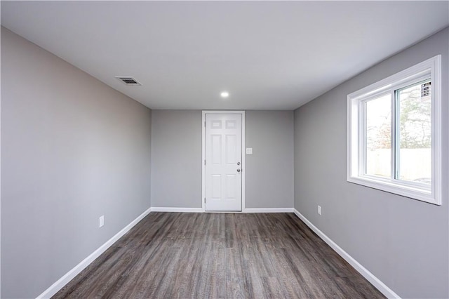 spare room featuring dark wood-type flooring