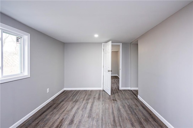 unfurnished room featuring dark hardwood / wood-style flooring