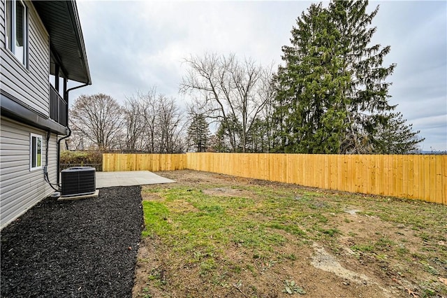 view of yard with cooling unit and a patio area