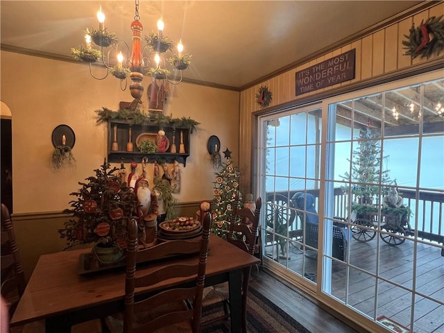 dining room featuring a chandelier, hardwood / wood-style floors, and crown molding