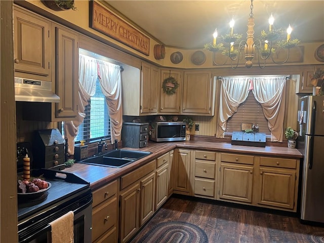 kitchen with butcher block counters, sink, pendant lighting, extractor fan, and appliances with stainless steel finishes