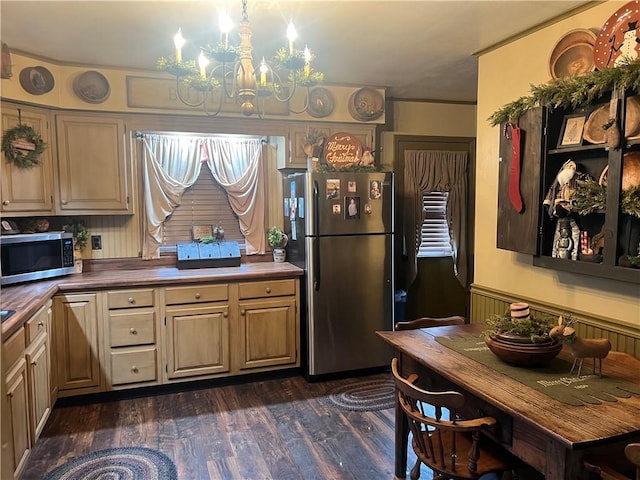 kitchen with stainless steel appliances, decorative light fixtures, an inviting chandelier, butcher block countertops, and dark hardwood / wood-style floors