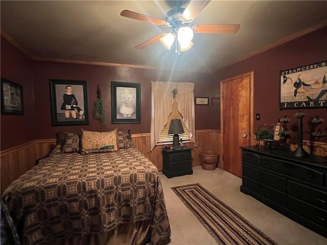 bedroom with ceiling fan, crown molding, and carpet floors