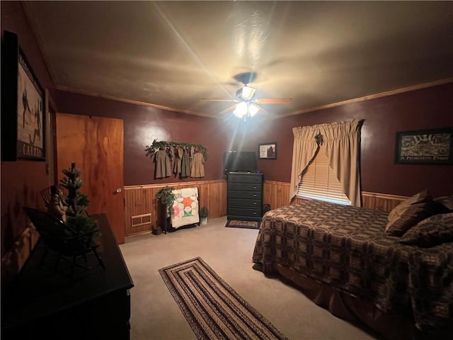 bedroom with ceiling fan, crown molding, and light carpet