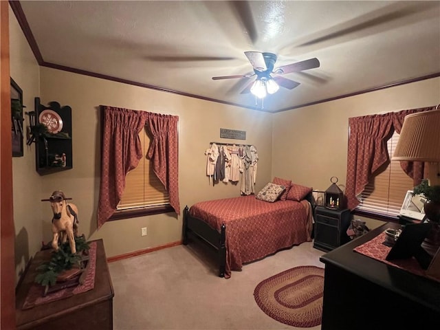 bedroom featuring ceiling fan, crown molding, and carpet floors