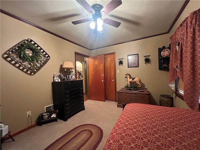 bedroom featuring light carpet, ceiling fan, and ornamental molding