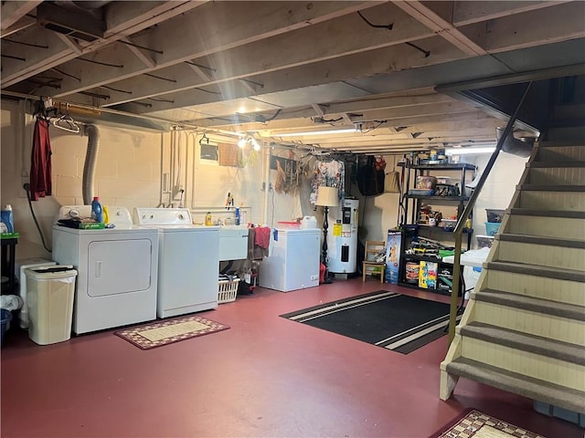 basement featuring sink, electric water heater, and washing machine and clothes dryer