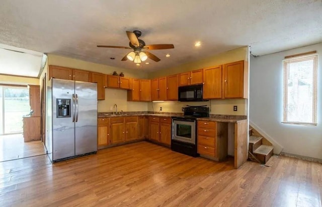 kitchen with ceiling fan, sink, light hardwood / wood-style floors, and appliances with stainless steel finishes