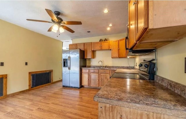 kitchen with stove, ceiling fan, sink, stainless steel fridge with ice dispenser, and light hardwood / wood-style floors