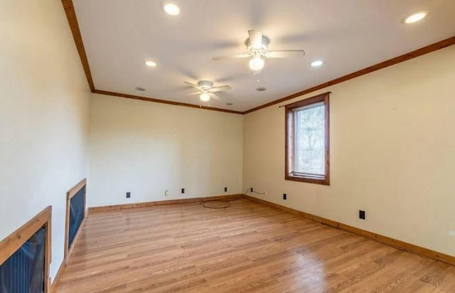 unfurnished room featuring ceiling fan, light hardwood / wood-style floors, and crown molding