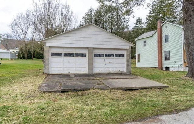 garage featuring a lawn