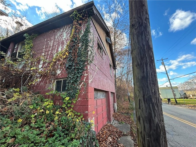 view of side of home featuring a garage