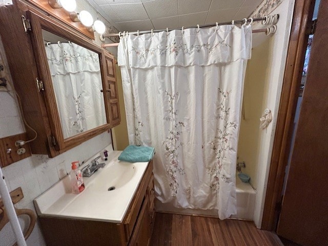 bathroom featuring shower / bathtub combination with curtain, vanity, and hardwood / wood-style flooring