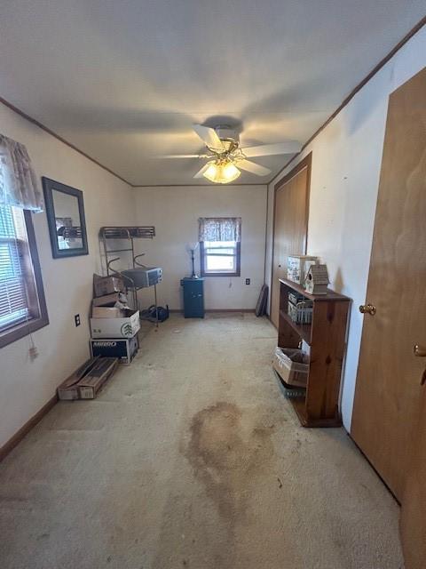 misc room featuring ceiling fan and light colored carpet