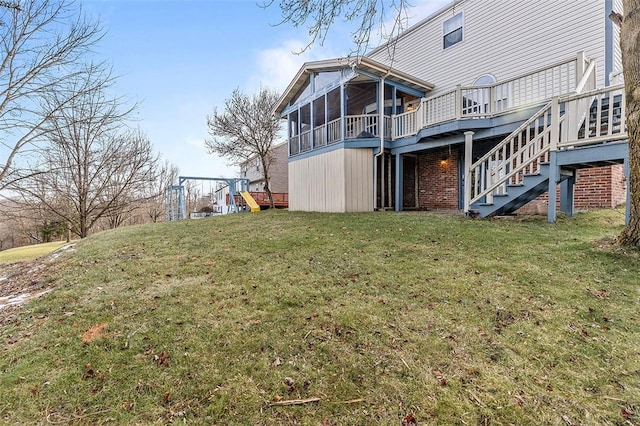 exterior space with a lawn, a wooden deck, and a sunroom