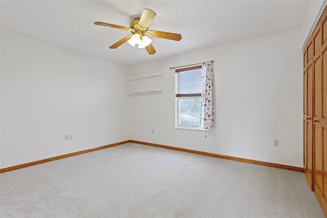 carpeted empty room with ceiling fan