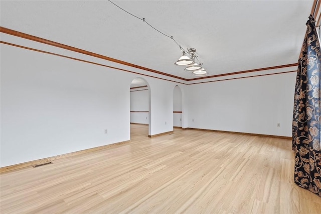 unfurnished living room with crown molding and light hardwood / wood-style flooring