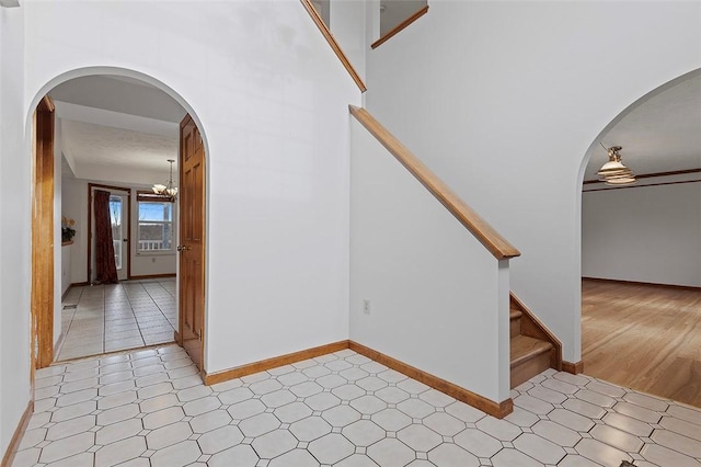 stairs with an inviting chandelier