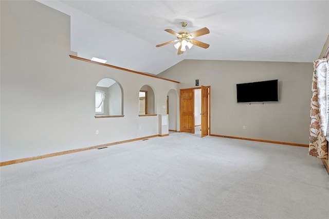 unfurnished living room featuring ceiling fan, light colored carpet, and vaulted ceiling