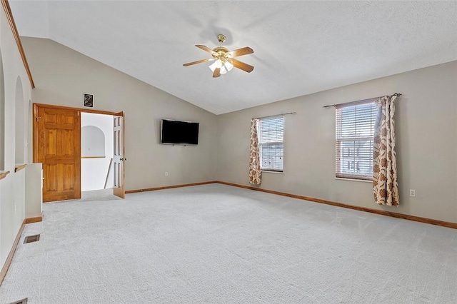 carpeted spare room featuring ceiling fan and lofted ceiling