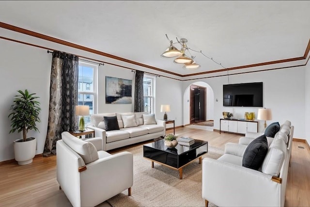 living room with light hardwood / wood-style flooring and ornamental molding