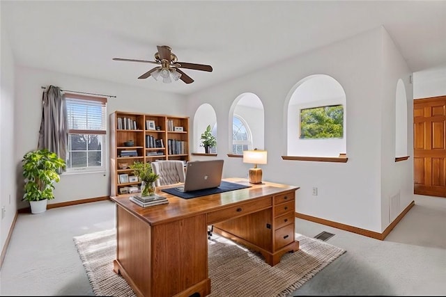 home office with light carpet and ceiling fan