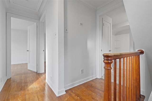 corridor with hardwood / wood-style floors and ornamental molding