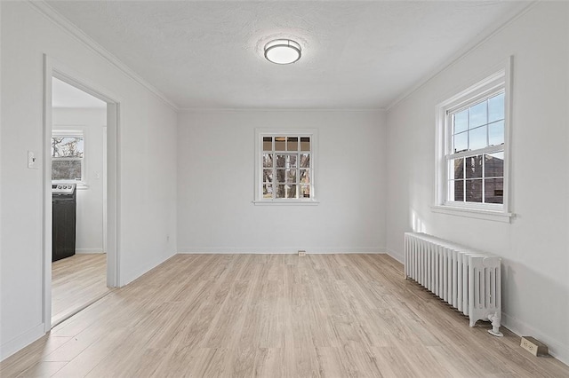 unfurnished room with radiator, crown molding, light hardwood / wood-style floors, and a textured ceiling