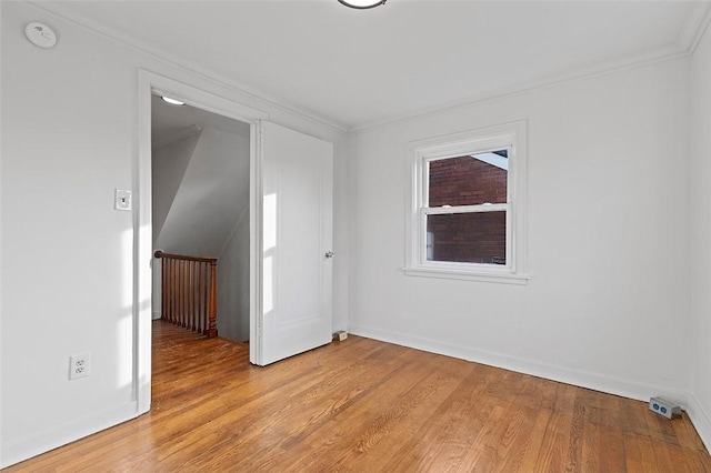 unfurnished room with light hardwood / wood-style flooring and ornamental molding