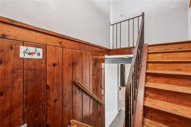 staircase with wood walls