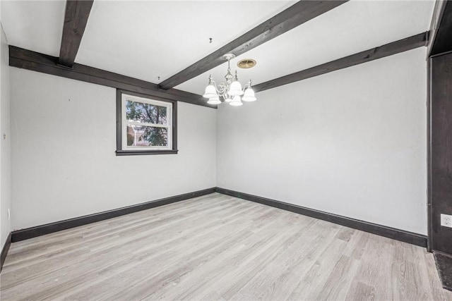 empty room featuring beam ceiling, light wood-type flooring, and a chandelier