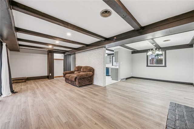 interior space with beam ceiling and light hardwood / wood-style flooring