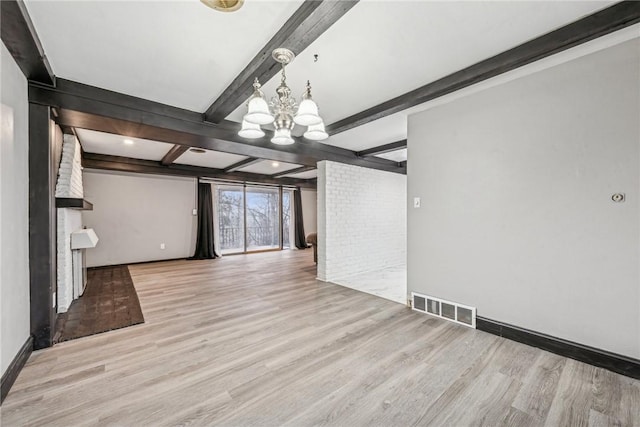 interior space with beamed ceiling, light hardwood / wood-style flooring, and a notable chandelier