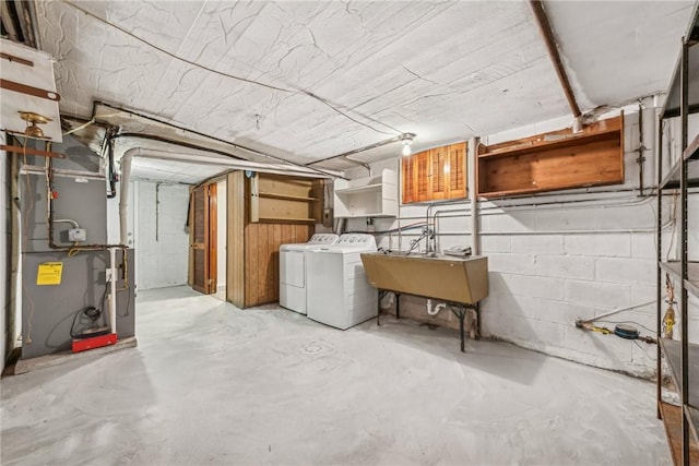 basement with sink and washing machine and clothes dryer