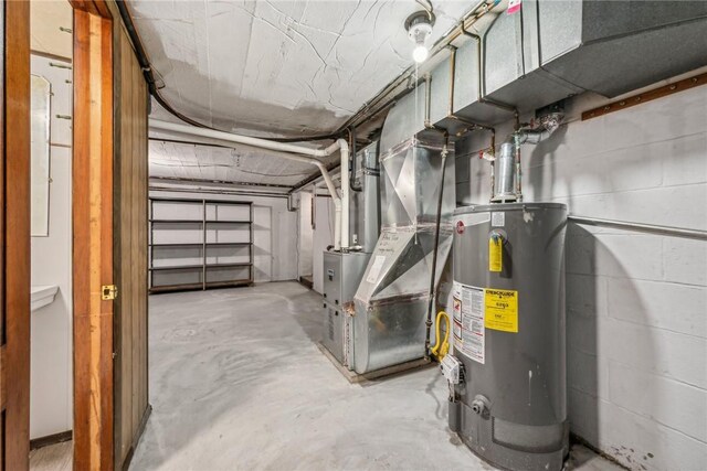 utility room featuring heating unit and water heater