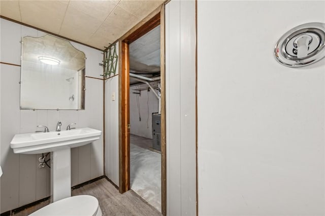 bathroom with hardwood / wood-style flooring and toilet