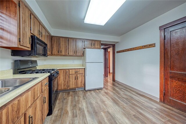 kitchen featuring light hardwood / wood-style floors and black appliances