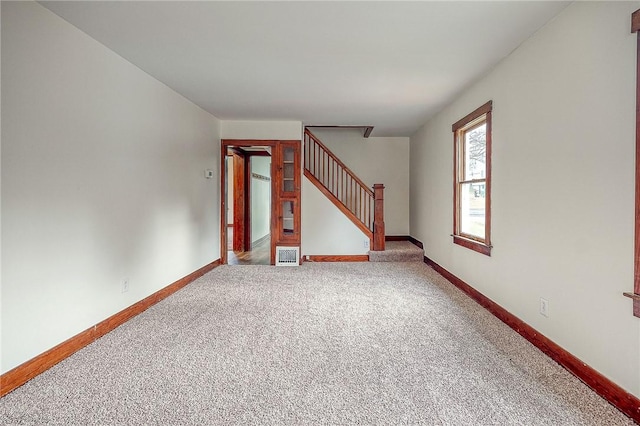 unfurnished living room featuring carpet flooring