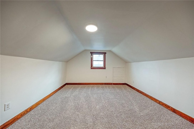 additional living space with carpet floors and lofted ceiling